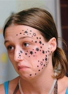 a woman with black stars painted on her face