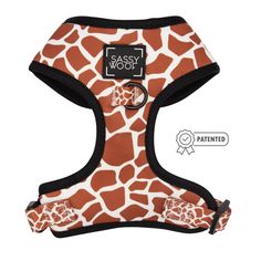 an orange and white giraffe print dog harness with the words sasy woof on