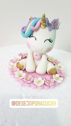 there is a small figurine that looks like a unicorn on top of flowers