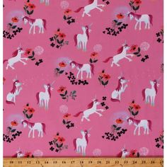 a pink background with white unicorns and flowers on the bottom right corner is a ruler