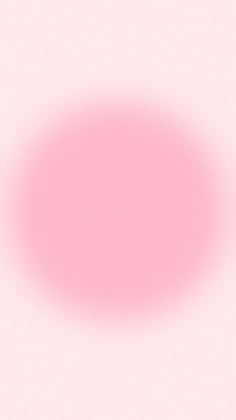 an orange and pink object is shown in the middle of a blurry image on a white background