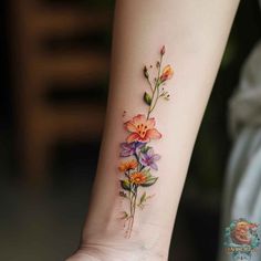 a woman's wrist with flowers on it