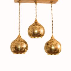 three golden hanging lights on a white background