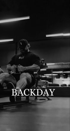 a man sitting in a chair with his legs crossed and the words backday written across it