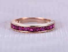 a close up of a pink ring on a white surface