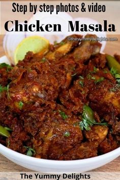 chicken masala in a bowl with lemon wedges