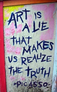 graffiti on the side of a building that says art is a lie that makes us realize the truth