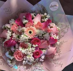 a bouquet of pink roses and white flowers