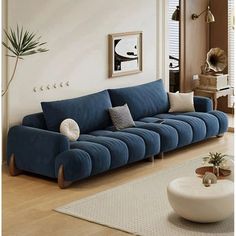 a living room with a blue couch and white rug