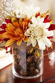 a vase filled with flowers sitting on top of a table