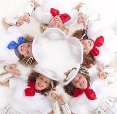 a group of women dressed in white and red