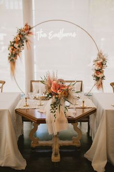 the table is set with white linens and floral centerpieces, along with gold chargers