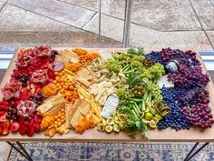 a wooden table topped with lots of different types of food