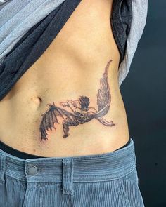 a woman with a tattoo on her stomach is holding onto the side of her body