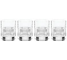 four glasses are lined up next to each other