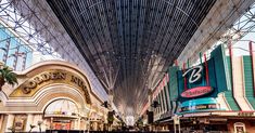 the inside of a shopping mall with people walking around