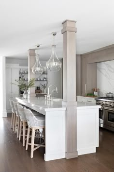 a large kitchen with an island in the middle and lots of counter space on one side