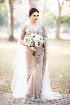 a woman in a wedding dress holding a bouquet