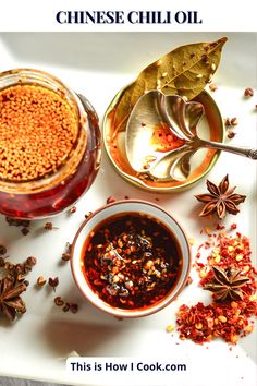 three bowls filled with different types of spices and herbs on top of a white surface