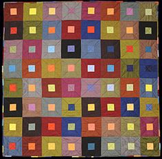 a multicolored quilt with squares on it