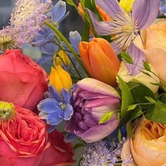 an arrangement of colorful flowers in a vase