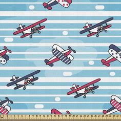 an airplane and plane pattern on blue fabric