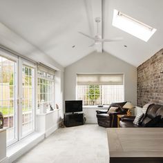 a living room filled with furniture and a flat screen tv