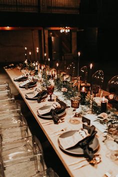 a long table is set with candles and plates