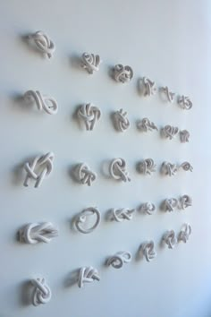 the letters are made out of clay and have been placed on the wall to look like swirls