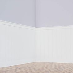 an empty room with white walls and wood flooring is pictured in this image, there are no people or objects on the wall