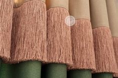 a row of different colored curtains with fringes