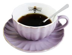 a cup of coffee with a spoon in it and saucer on the side, against a white background