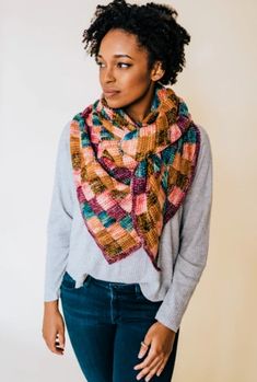 a woman wearing a multicolored knitted scarf