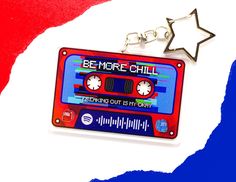 a red, white and blue cassette keychain with a star on it