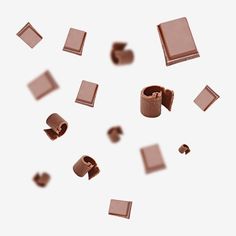 several pieces of chocolate falling into the air