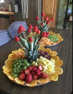 fruit platter with pineapples, grapes, strawberries and oranges