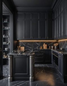 an elegant kitchen with black cabinets and marble counter tops, along with stainless steel appliances