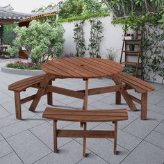 a wooden table and bench sitting in the middle of a courtyard