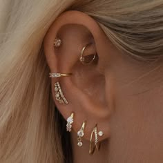 a woman's ear with three different types of piercings