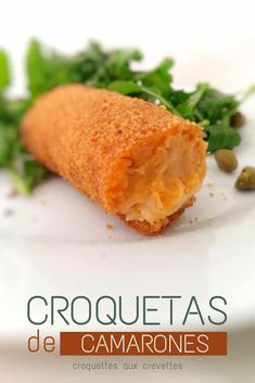 a close up of food on a plate with text that reads croquettass de camarones