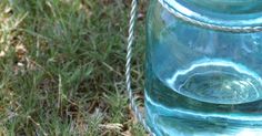 a blue glass jar sitting in the grass