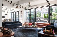 a living room filled with furniture and lots of windows