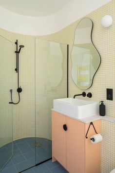 a bathroom with a sink, mirror and shower head in the corner on the wall