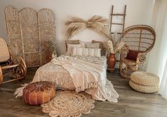 a bedroom with wicker furniture and accessories on the floor, including a bed covered in blankets