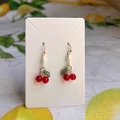 Gold Dangle Earrings Feature Red Cherry Charms And Pearls With French Ball Ear Hooks. Also Available As A Set Approximately 1.5 Inch Drop Silicone Stoppers Included Ships Within 2 Business Days Customization Available Made To Order Made With Love And Care Cherry Earrings, Mini Pearl, Charm Dainty, Cute, Coquette, Cottagecore, Casual Retro Earrings / Dainty, Cool, Bead, Beaded, Gift, Neutral, Fruit, Daily Wear, Everyday Wear, Boho, Minimalist, Fairy, Fairycore, Sweet, Girlhoodcore, Anniversary Gi Pretty Handmade Jewelry, Fun Beaded Jewelry, Cute Earrings Ideas, How To Make Mini Earrings, Wired Beaded Jewelry, Jewellery Design Earrings, Earring With Beads, Jewelry With Charms, Bead And Clay Earrings