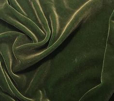 a close up view of a green velvet fabric with very thin lines on the edges