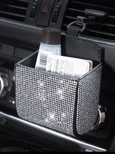 the interior of a car with a cup holder and magazine holders on it's dash console