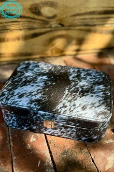 a black and white case sitting on top of a wooden floor