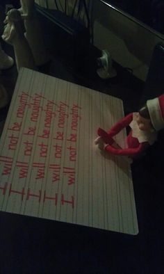 an elf is writing on a piece of paper