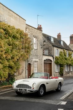 an old car is parked on the side of the road